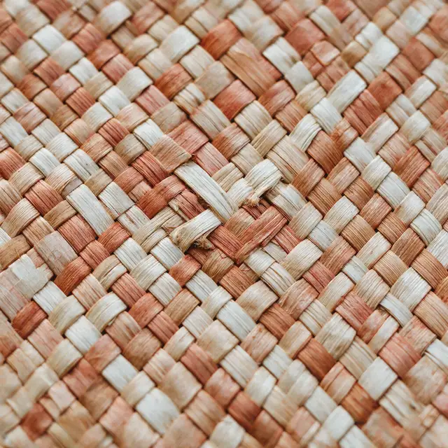 Close-up of hand-woven natural fibre in cream and terracotta
